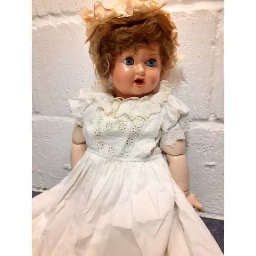 248 - A 20th Century Continental doll with painted face and open mouth, jointed arms and legs wearing an e... 