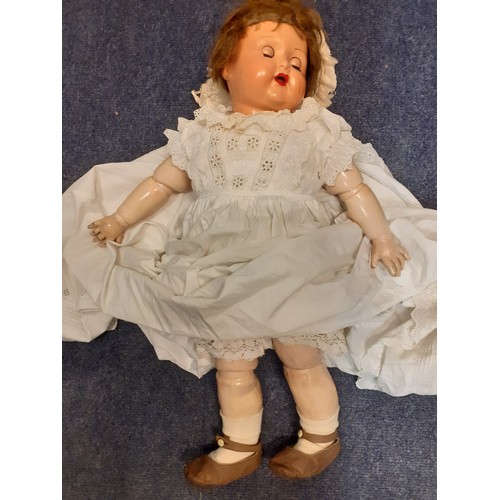 248 - A 20th Century Continental doll with painted face and open mouth, jointed arms and legs wearing an e... 