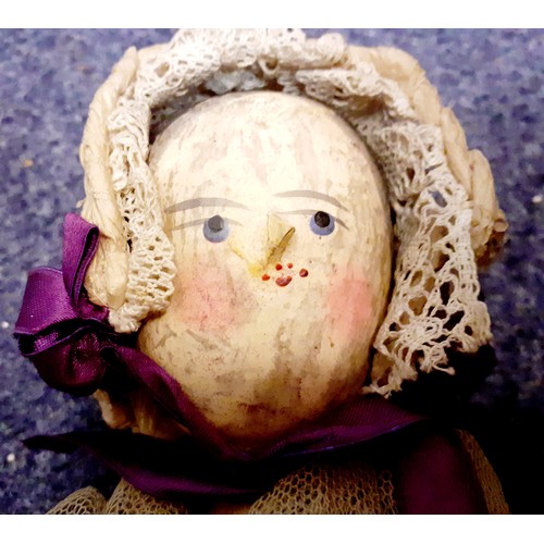 115 - A Victorian American peg doll having a painted face with nose addition, 33cm high together with a pa... 