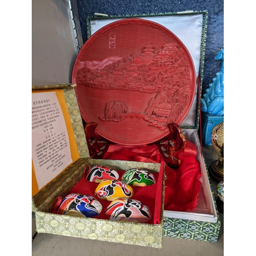 102 - A mixed lot of oriental items to include a boxed red Cinnabar carved lacquered plate on wooden stand... 