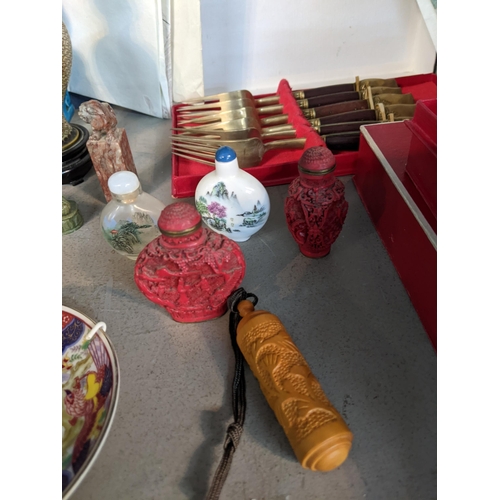 102 - A mixed lot of oriental items to include a boxed red Cinnabar carved lacquered plate on wooden stand... 