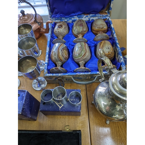 106 - A mixed lot of silver plate, metal wares and other items to include a boxed set of six onyx goblets,... 