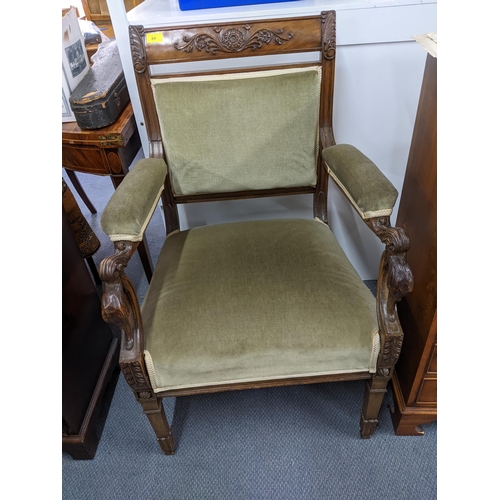 84 - An Edwardian walnut carved and upholstered open armchair, the arms with carved, scrolled leaf and bi... 