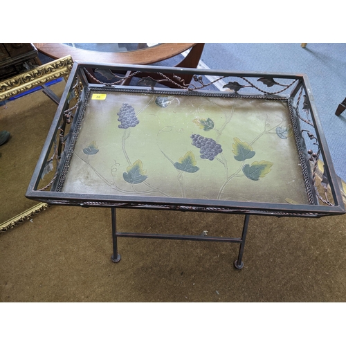 86 - A painted metal folding tray topped table, having grape and wine leaf decoration, 57 x 63 x 41cm, al... 