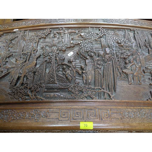 70 - A Chinse camphor wood carved chest, domed top with a relief carved landscape panel of figures in gar... 