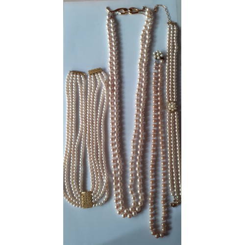 125 - Four simulated pearl necklaces to include a Le Bijou 2 strand necklace with gold tone and white crys... 