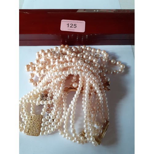 125 - Four simulated pearl necklaces to include a Le Bijou 2 strand necklace with gold tone and white crys... 