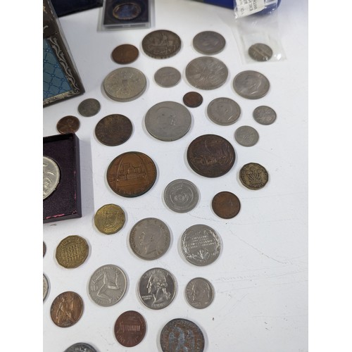 140 - Numismatic Interest - A coin collection album, presentation case, cash tin, along with a mixed group... 