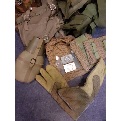 247 - A collection of green canvas Cold War USA and German uniform accessories A/F to include ruck sacks, ... 