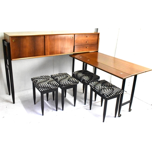 A 1960s White & Newton rare combo teak unit designed by Arthur Edwards, consisting of a sideboard having two sliding doors and three drawers, raised above a pull out fall flap table standing on castors, with four stools having lacquered tapering lacquered legs, 109cm high x 175cm wide. Location:A4B