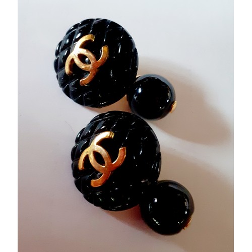 2A - Chanel- A pair of 1994 Autumn collection black Matrasse Coco cufflinks with gold tone interlocking C... 
