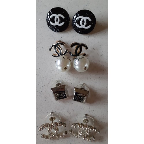 138 - Four pairs of fashion earrings in the style of various fashion designers. Location: Cab1