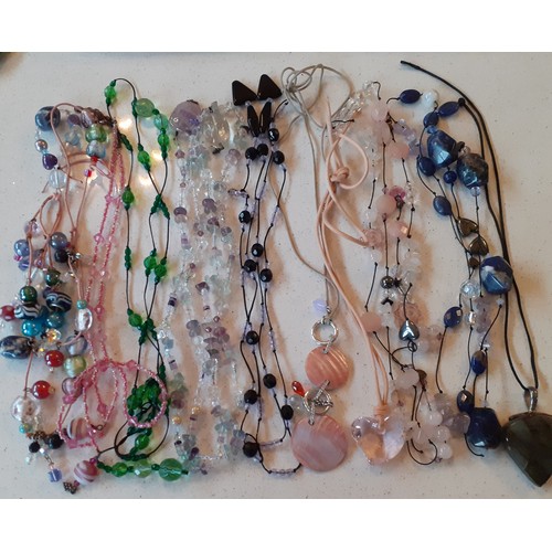 139 - A quantity of modern stone and glass bead necklaces mostly on string and leather straps to include a... 