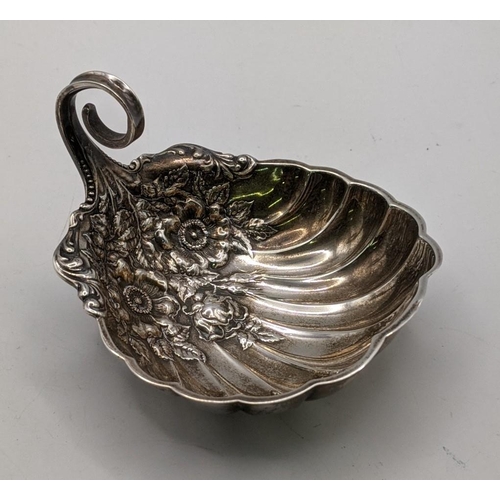 A sterling silver dish with embossed floral ornament and scrolled handle, stamped R 131g
Location: A4F