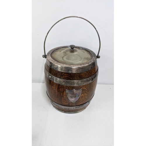 317 - A mixed lot to include a Poole Pottery ow. an oak biscuit barrel with silver plated fittings, a pewt... 