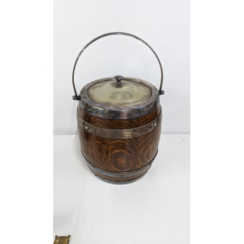 317 - A mixed lot to include a Poole Pottery ow. an oak biscuit barrel with silver plated fittings, a pewt... 