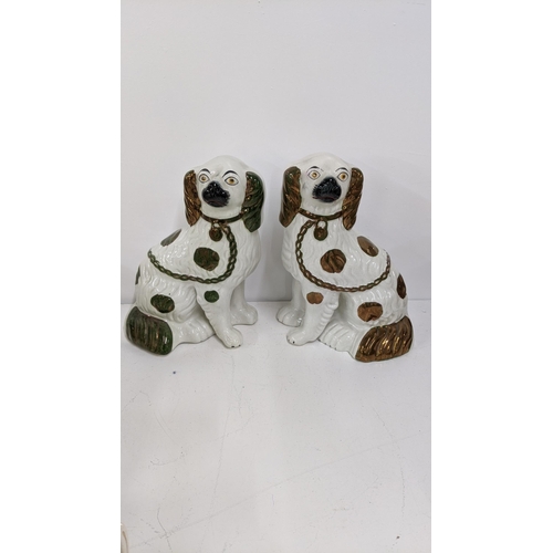 322 - A pair of Victorian Staffordshire king Charles Spaniels 24cmH together with character jugs, an 18th ... 