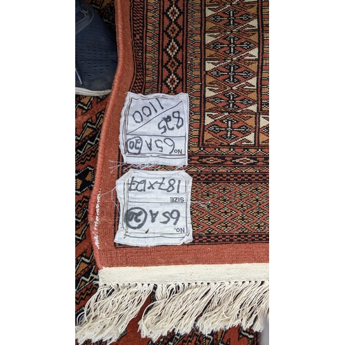 325 - A Bokhara hand woven red ground rug having geometric designs and tasselled ends, 190cm x 126cm
Locat... 