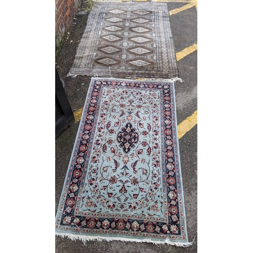 391 - Two hand woven rugs to include an Indian floral design rug, 160cm x 94.5cm, and a Pakistani rug havi... 