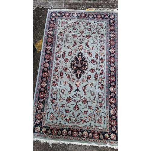 391 - Two hand woven rugs to include an Indian floral design rug, 160cm x 94.5cm, and a Pakistani rug havi... 