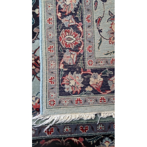 391 - Two hand woven rugs to include an Indian floral design rug, 160cm x 94.5cm, and a Pakistani rug havi... 