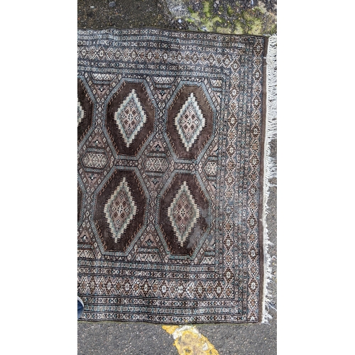 391 - Two hand woven rugs to include an Indian floral design rug, 160cm x 94.5cm, and a Pakistani rug havi... 