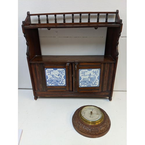 299 - A late 19th century mahogany shelf with twin tiled doors, and a carved barometer Negretti & Zambra
L... 