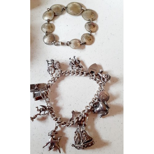 216 - A quantity of jewellery and collectables to include a white metal charm bracelet, a coin bracelet, a... 