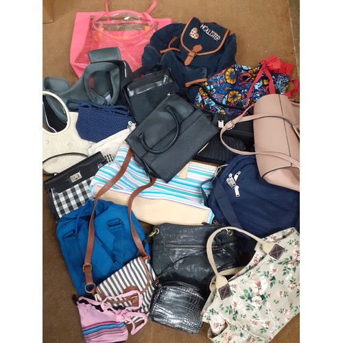 155 - A quantity of High Street fashion bags to include a Hollister back-pack, a Cuby dog carrier, a Rebec... 