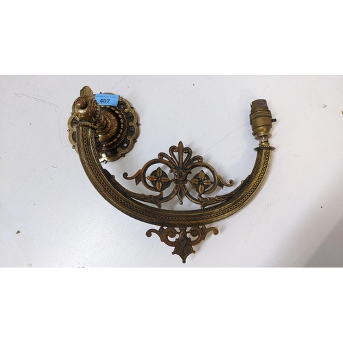 407 - An art nouveau brass folding wall light with flower ornament, 26cm h x 35cm w
Location:A1M