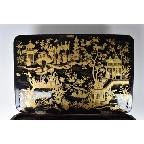 125 - An early 19th century chinoiserie black lacquered and gilt highlighted work box, the box of rounded ... 