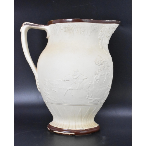 133 - A circa 1800 Turner stoneware jug, moulded decoration depicting a hunting scene and with brown paint... 