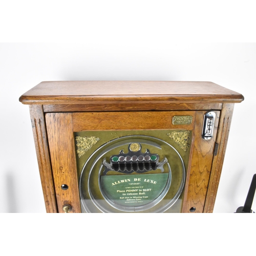 142 - An Allwin De Luxe oak cased penny slot machine, circa 1920, with internal metal ball track, central ... 