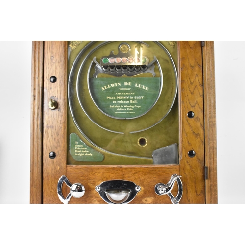 142 - An Allwin De Luxe oak cased penny slot machine, circa 1920, with internal metal ball track, central ... 