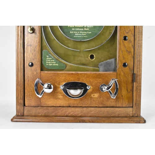 142 - An Allwin De Luxe oak cased penny slot machine, circa 1920, with internal metal ball track, central ... 