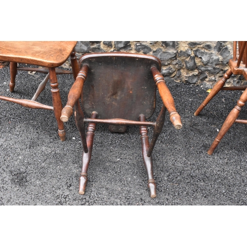 144 - A set of four 19th century elm and ash Windsor dining chairs, having spindle hoop shaped backs, turn... 