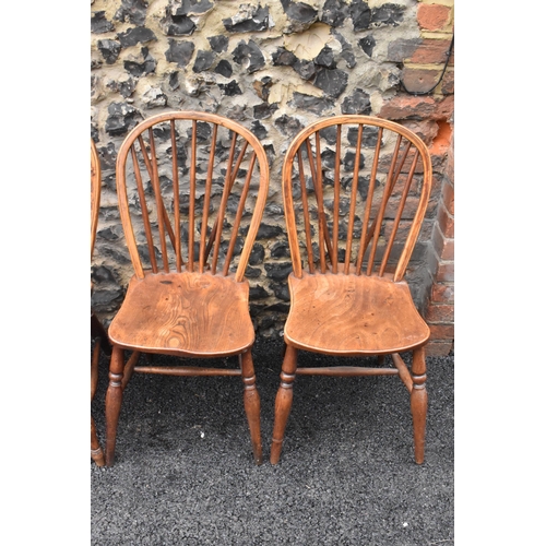 144 - A set of four 19th century elm and ash Windsor dining chairs, having spindle hoop shaped backs, turn... 