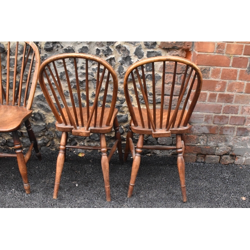 144 - A set of four 19th century elm and ash Windsor dining chairs, having spindle hoop shaped backs, turn... 