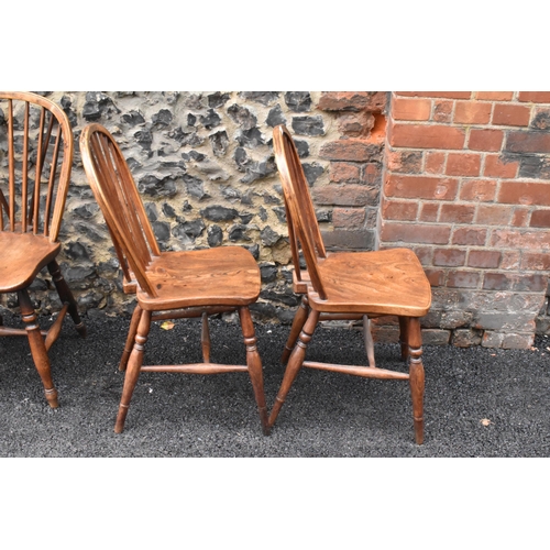 144 - A set of four 19th century elm and ash Windsor dining chairs, having spindle hoop shaped backs, turn... 