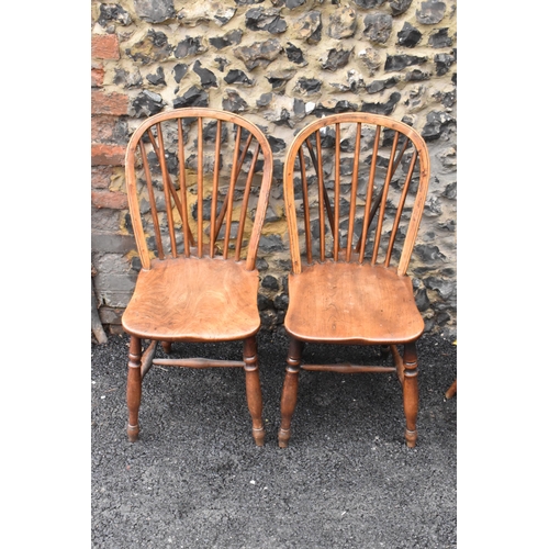 144 - A set of four 19th century elm and ash Windsor dining chairs, having spindle hoop shaped backs, turn... 