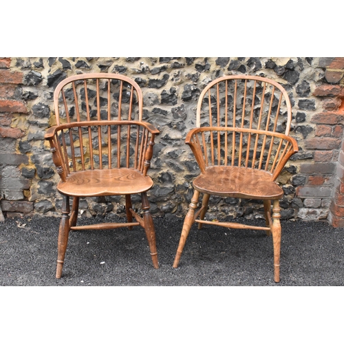 145 - A pair of 19th century elm and ash Windsor carver dining chairs, having spindle hoop shaped backs, t... 