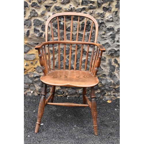 145 - A pair of 19th century elm and ash Windsor carver dining chairs, having spindle hoop shaped backs, t... 