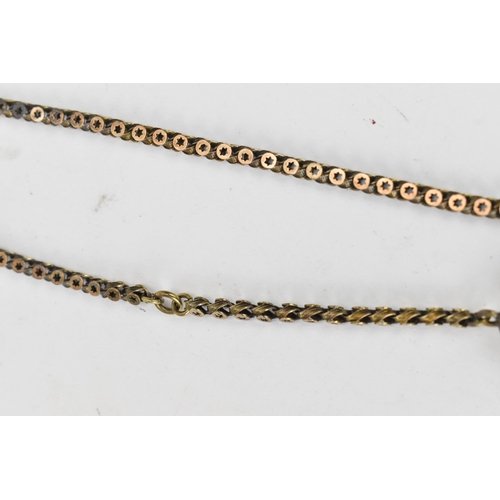 66 - A Victorian yellow metal Albertina pocket watch chain having a fancy tassel charm and a 15ct gold do... 