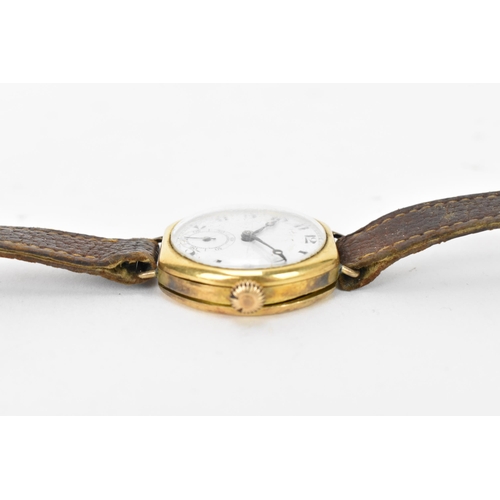 73 - A 1920s, manual wind, gents, 18ct gold wristwatch, having a white enamel dial, subsidiary seconds di... 