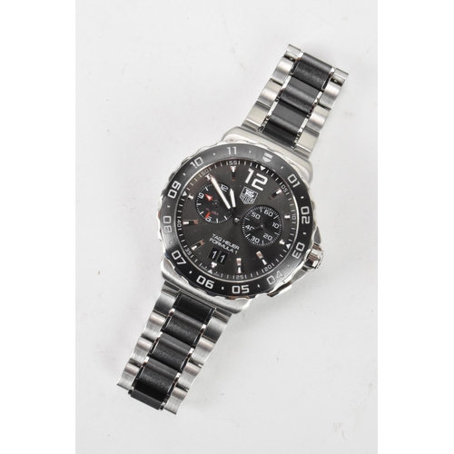 80 - A Tag Heuer Formula 1, quartz, alarm, gents, stainless steel wristwatch, having a black dial, two su... 