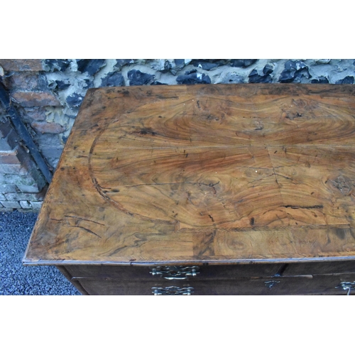 152 - A circa 1700 walnut chest of drawers, having a quarter cut veneered and cross banded top, two short ... 