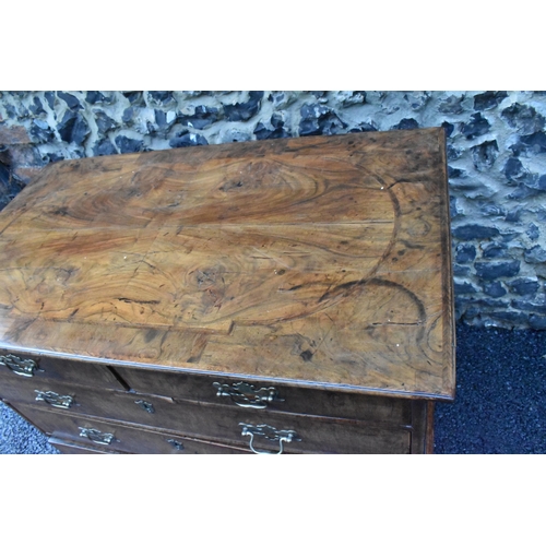 152 - A circa 1700 walnut chest of drawers, having a quarter cut veneered and cross banded top, two short ... 