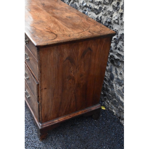 152 - A circa 1700 walnut chest of drawers, having a quarter cut veneered and cross banded top, two short ... 