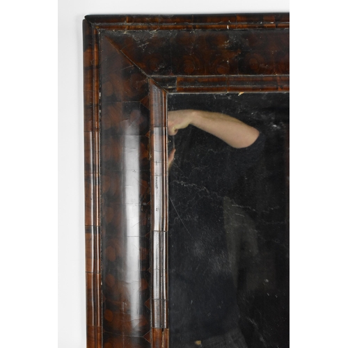 157 - A William and Mary walnut oyster veneered mirror, circa 1690, having a cushion moulded frame, the gl... 