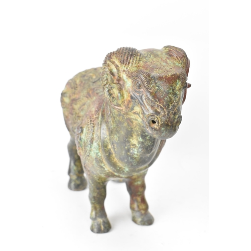 177 - A Chinese patinated bronzed Zodiac model of a ram, relief decorated with snakes, dragons and repeati... 